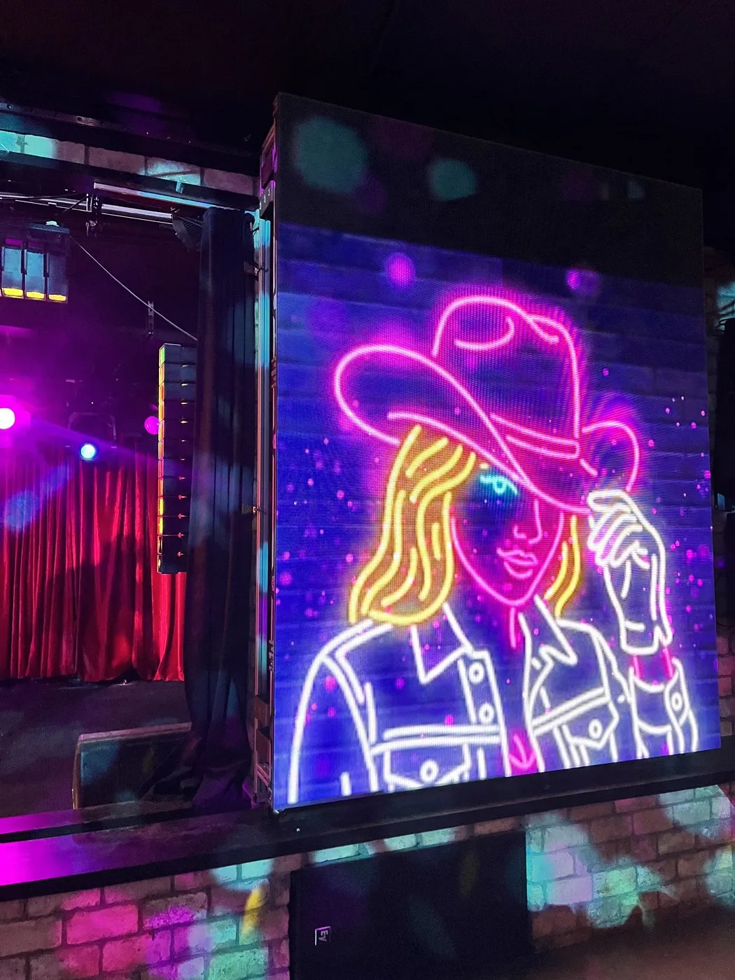 The neon cowgirl sign